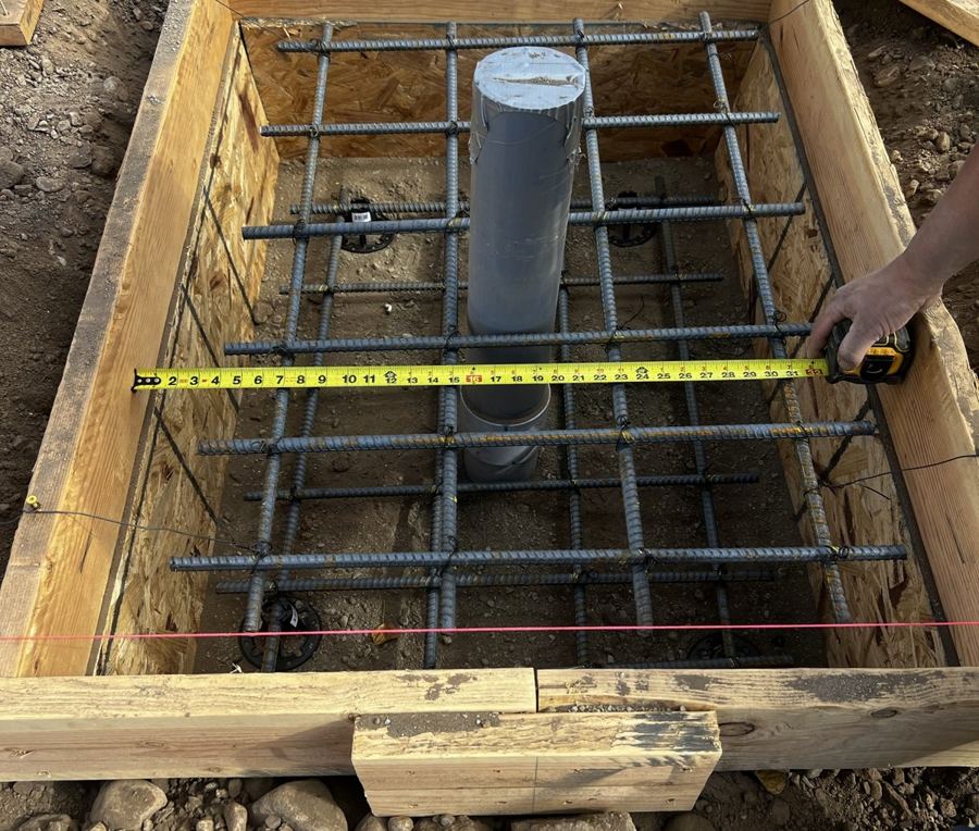 Rebar cage and conduit stubs set before a concrete pour